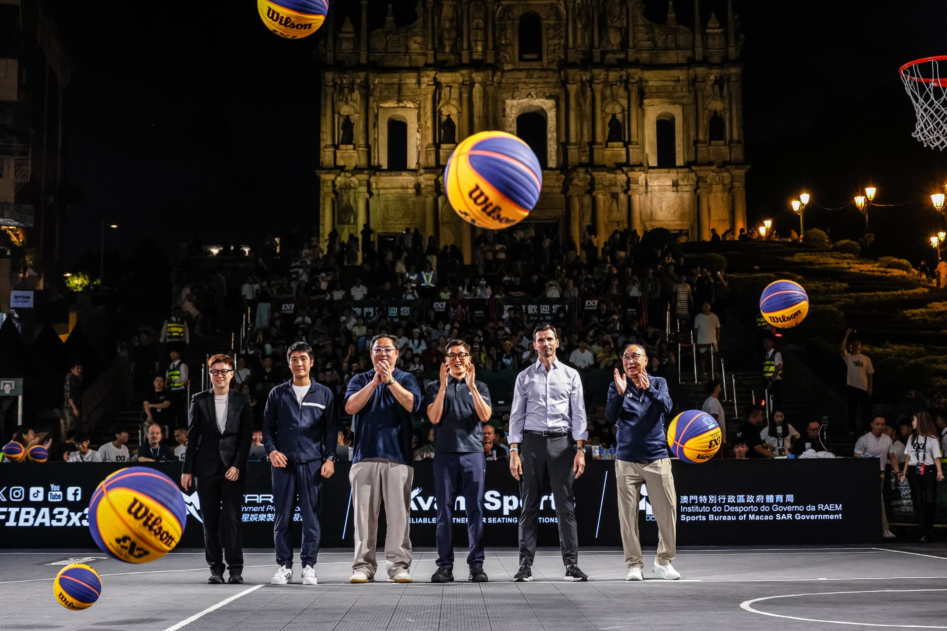 Officials applaud as FIBA 3x3 basketballs are tossed in the air at the opening of World Tour Macau 2026